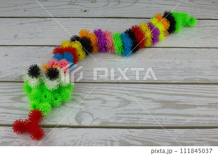 Toy snake made of multi colored burdocks 111845037