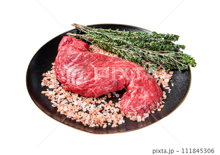 Raw Machete beef meat steak or hanging tender cut on plate with sea salt and thyme. Isolated on white background. Top view. 111845306