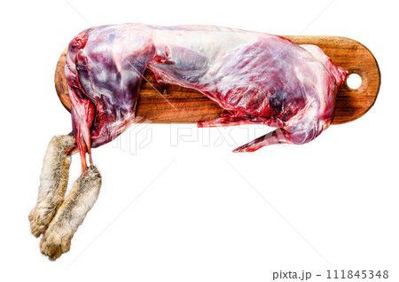 Whole forest wild hare, raw meat on wooden deck, old black rustic table. Isolated on white background. Top view. 111845348