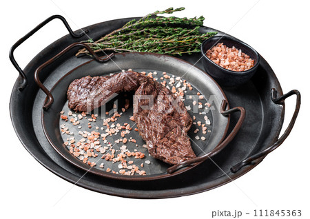 BBQ Grilled Machete or skirt beef meat steak in steel tray. Isolated on white background. Top view. BBQ Grilled Machete or skirt beef meat steak in steel tray. Isolated on white background. Top view. 111845363