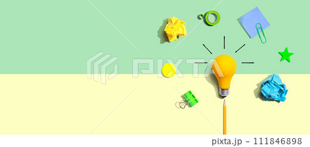 Brainstorming concept with a light bulb and school supplies - Flat lay 111846898