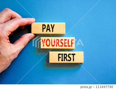 Pay yourself first symbol. Concept words Pay yourself first on beautiful wooden blocks. Beautiful blue table blue background. Businessman hand. Business and pay yourself first concept. Copy space. 111847790