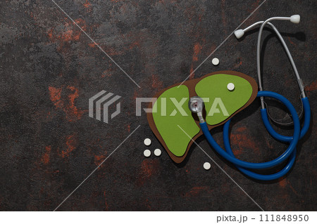 Paper liver mockup and stethoscope on dark gray background, space for text 111848950