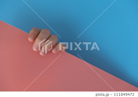 Stylish nude beige female nails on blue pink background. Modern trendy stylish Beautiful manicure. Cute pastel nail minimalistic design concept of beauty treatment. Gel nails. Skin care Stylish nude beige female nails on blue pink background. Modern trendy stylish Beautiful manicure. Cute pastel nail minimalistic design concept of beauty treatment. Gel nails. Skin care 111849472