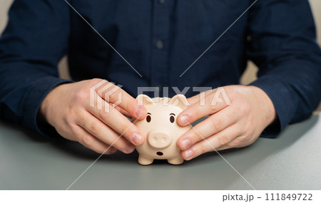 Use of last savings. Money problem. Bankruptcy, getting into debt. Difficult life situation. A man wants to break his piggy bank and take his savings. Refinancing and debt restructuring. 111849722