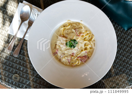 A Freshly Prepared and Delicious Spaghetti Carbonara Served on the Dining Table A Freshly Prepared and Delicious Spaghetti Carbonara Served on the Dining Table 111849995