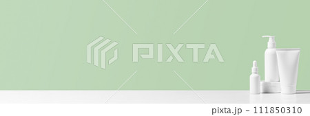 Banner with cosmetic products on the table, white bottles and containers Banner with cosmetic products on the table, white bottles and containers 111850310