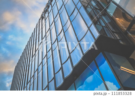 Modern Glass Skyscraper Reflecting Blue Sky in Downtown Metropolis Dec 31 2023 Modern Glass Skyscraper Reflecting Blue Sky in Downtown Metropolis Dec 31 2023 111853328