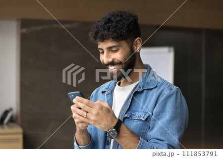 Happy young Arab business project manager guy using online application Happy young Arab business project manager guy using online application 111853791