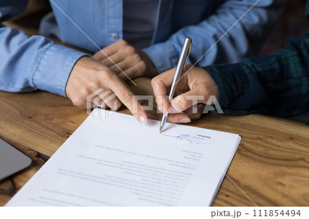 Female client and manager signing paper agreement, ending meeting Female client and manager signing paper agreement, ending meeting 111854494