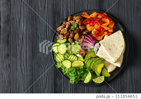 vegan fajitas with mushrooms, veggies on a plate 111854651