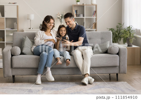 Happy young couple and little kid talking on video call 111854910