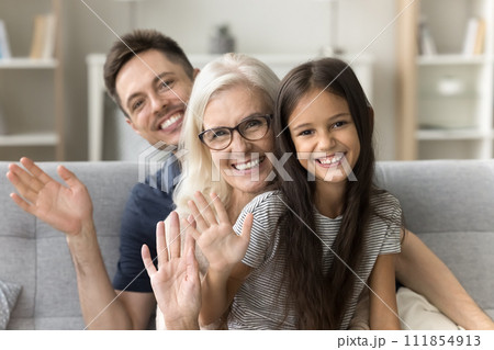 Cheerful kid girl, grandma and handsome dad looking at camera Cheerful kid girl, grandma and handsome dad looking at camera 111854913