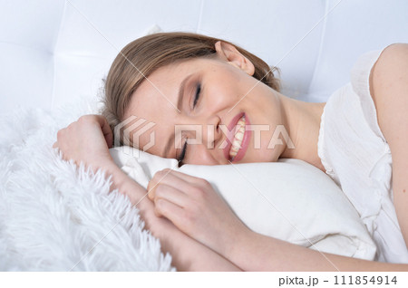 Portrait of young woman sleeping in bed at home 111854914