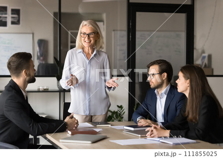 Positive motivated business leader woman holding teamwork meeting 111855025