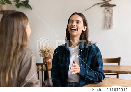 Two happy young female friends meeting at table 111855315