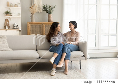 Loving mother enjoy pleasant conversation with grown up daughter 111855440