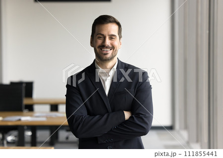 Happy successful businessman in formal jacket looking at camera 111855441