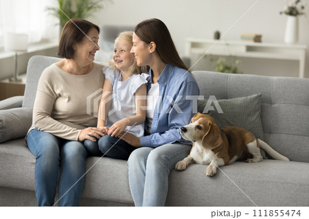 Happy mother, grandma and little child girl sitting on couch 111855474