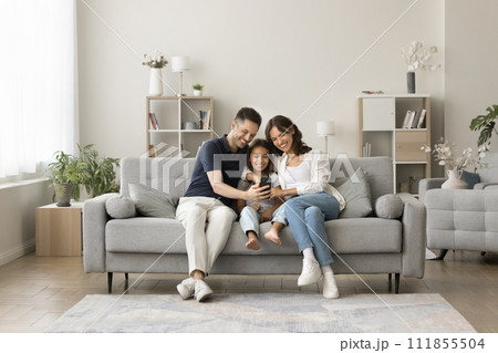 Positive mom, dad and sweet girl kid taking family selfie 111855504
