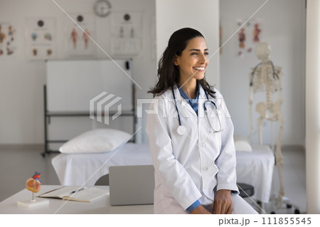 Happy young cardiologist woman posing at workplace Happy young cardiologist woman posing at workplace 111855545