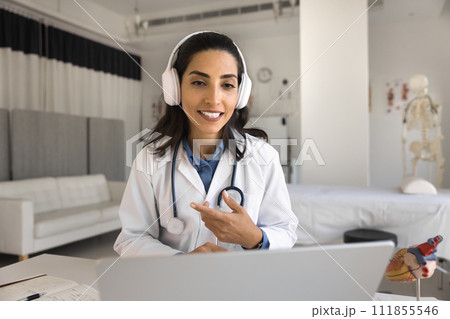 Positive young cardiologist doctor woman checking patients online Positive young cardiologist doctor woman checking patients online 111855546