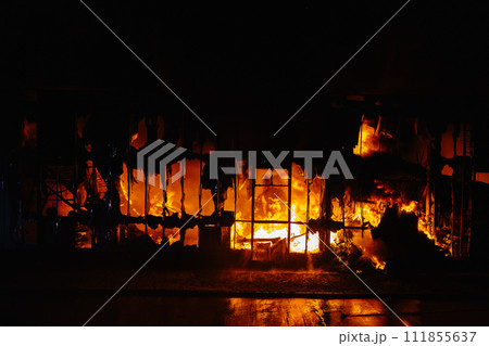 Fire Burning Inside Building at Night Fire Burning Inside Building at Night 111855637