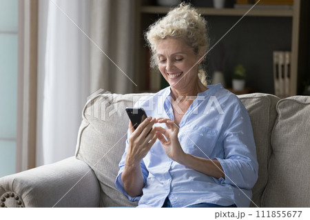 Aged woman hold smartphone, send messages, share news in sms Aged woman hold smartphone, send messages, share news in sms 111855677