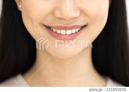 Toothy smile of happy Asian woman showing healthy white teeth Toothy smile of happy Asian woman showing healthy white teeth 111855678