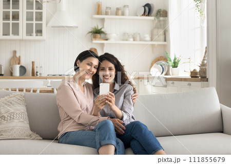 Happy mother and daughter using smart phone Happy mother and daughter using smart phone 111855679