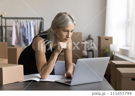 Small business owner workflow in warehouse using laptop Small business owner workflow in warehouse using laptop 111855799