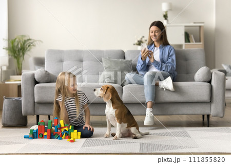 Happy mom taking picture of pet and child 111855820