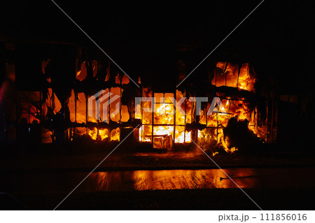 Fire Burning Inside Building at Night Fire Burning Inside Building at Night 111856016