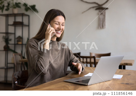 Cheerful remote professional employee woman speaking on cell 111856146
