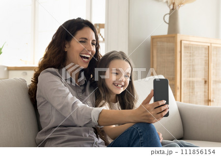 Laughing mom and kid using cellphone enjoy videocall 111856154