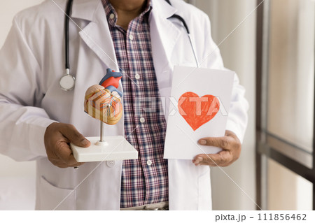 Hands of senior doctor holding greeting card with red heart 111856462