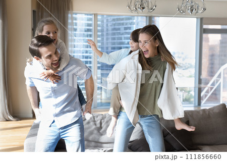 Family with kids enjoy leisure games in modern living room Family with kids enjoy leisure games in modern living room 111856660