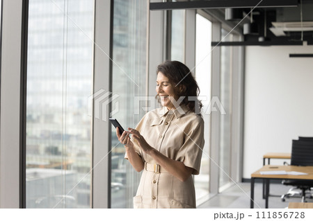 Happy mature business owner woman using Internet app 111856728