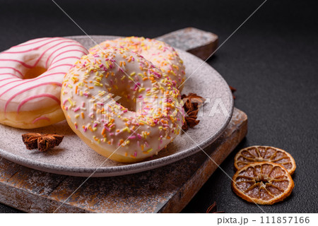 Delicious sweet bright donuts with cream on a plain background 111857166