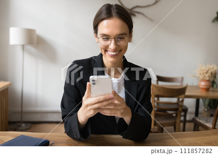 Happy young business professional woman using mobile phone Happy young business professional woman using mobile phone 111857282