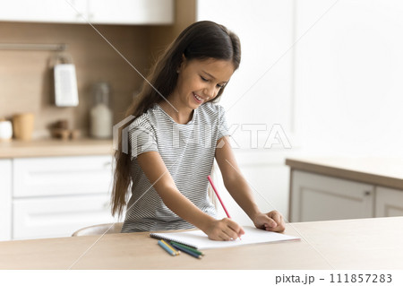 Cheerful little artist kid drawing funny picture in colorful pencils 111857283