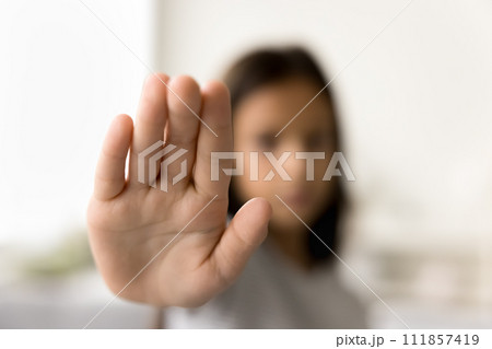 Scared kid making hand stop gesture, showing palm at camera 111857419