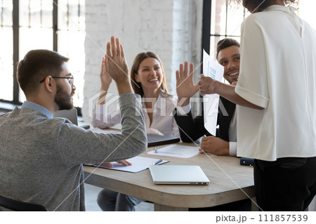 Happy employees raising hands to agree with executive 111857539