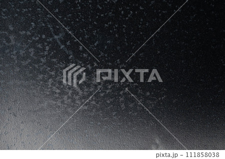 Black plastic background with gray spots 111858038