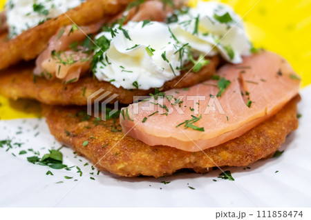 Potato pancakes with sour cream and herbs 111858474