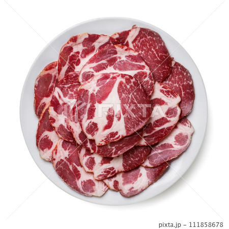 Cold cuts laid out in a plate on a white background. Top view. Cold cuts laid out in a plate on a white background. Top view. 111858678