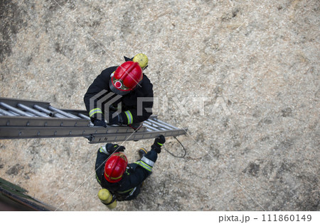 Firefighter climbs the stairs. Lifeguard training. Firefighter climbs the stairs. Lifeguard training. 111860149