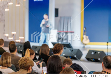 Public speaker at business event engaging audience from stage Public speaker at business event engaging audience from stage 111860246