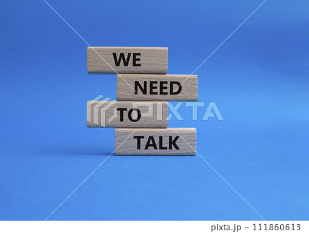 We need to talk symbol. Concept words We need to talk on wooden blocks. Beautiful blue background. Business and We need to talk concept. Copy space. 111860613