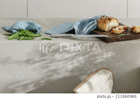 Sliced bread on wooden board, green beans linen bag and stainless still kitchen knife. Kitchen aesthetic concept 111860968